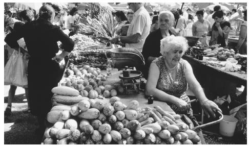 A woman sells produce at an open air market within the Diocletian Palace walls in Split.