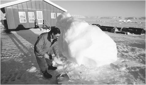 A person collecting ice for drinking water in Qaanaaq, Greenland. In Greenland's subarctic climate, temperatures average only fifty degrees at the height of summer, and only along the southwest coast.