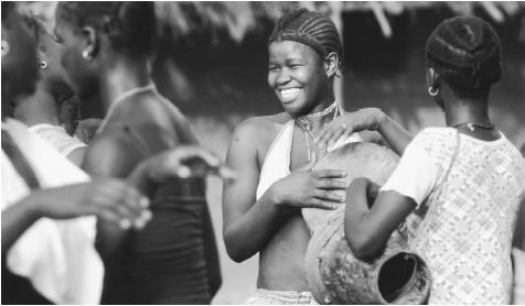 Teenagers from Bijagos Islands playing the drums. Almost all children receive primary education in Guinea-Bissau.