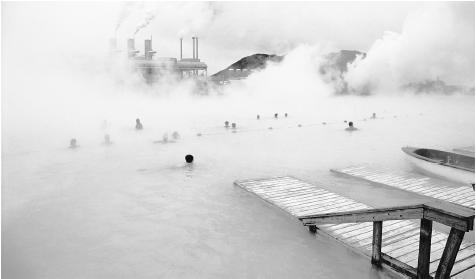 Swimmers bathe in the Blue Lagoon thermal baths in Iceland.