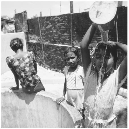 Young girls gather at a well. Almost half of the country's population is under fifteen years of age.