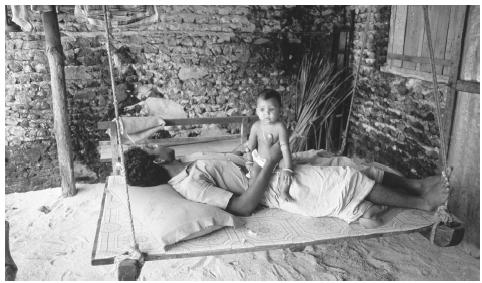 A Himmafushi Island man relaxes with his child. Most Maldivian households consist of nuclear families.