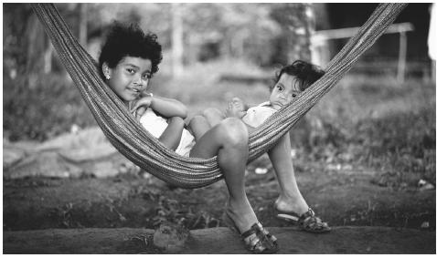 Nicaraguan children relax at their home in Managua. Households are generally comprised of six to eight persons, as an extended family.