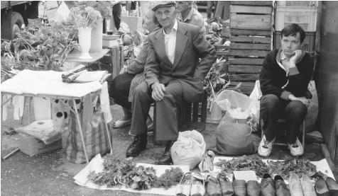 Produce and shoe merchants at a market in Plock.