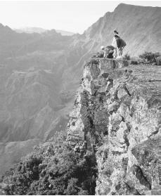 Hikers gaze on the beauty of Cirque de Malfate from the peak of Piton Meido on Reunion Island.