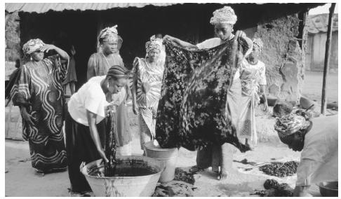 A group of women belonging to a cooperative make garas, a traditional tie-dyed cloth.