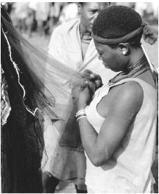 An Ethiopian woman looking at fabric in Fasher.