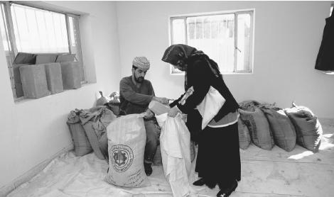 An Iraqi woman collects her monthly food rations from the Red Cross in Baghdad.