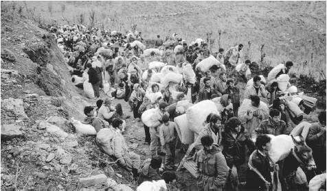 In March 1991, two million Kurds fled Iraq, settling at camps on the border to wait for humanitarian aid.